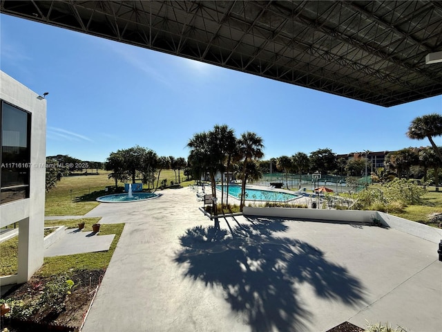 view of swimming pool with a patio area and a yard