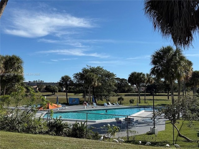 view of pool featuring a yard and a patio