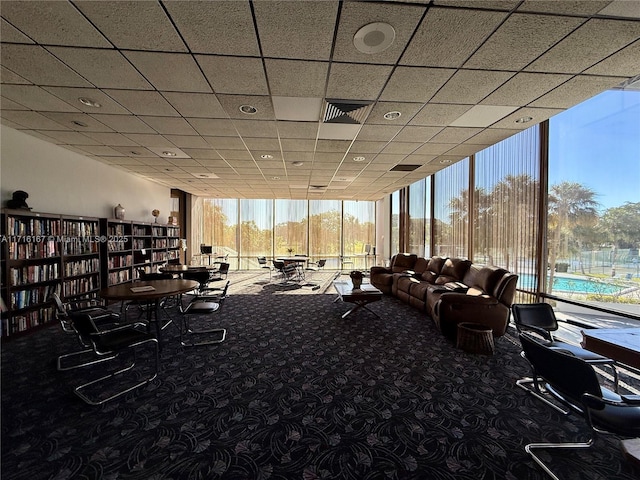 interior space with a wealth of natural light, carpet, and a wall of windows