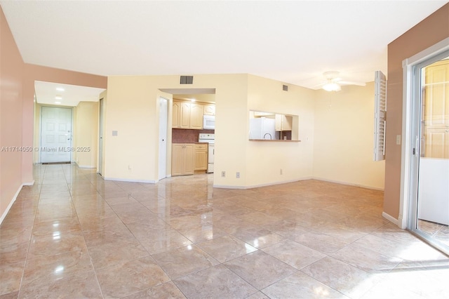 unfurnished living room featuring ceiling fan