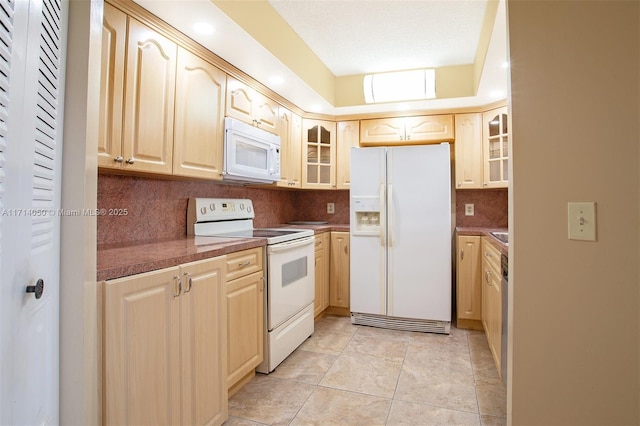 kitchen featuring light tile patterned flooring, light brown cabinetry, white appliances, and backsplash