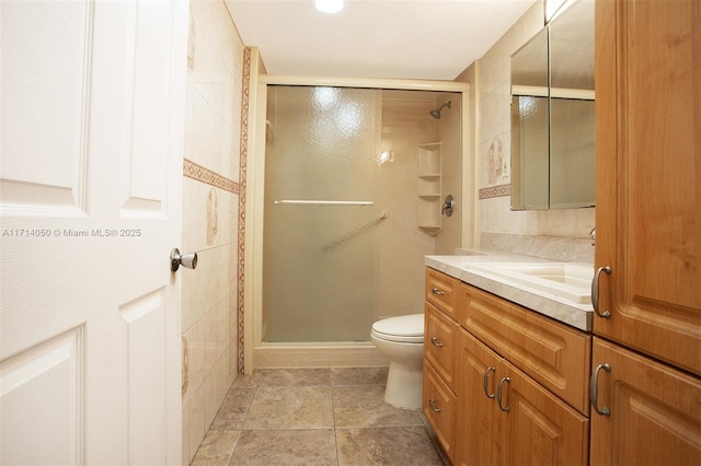 bathroom featuring vanity, toilet, and an enclosed shower