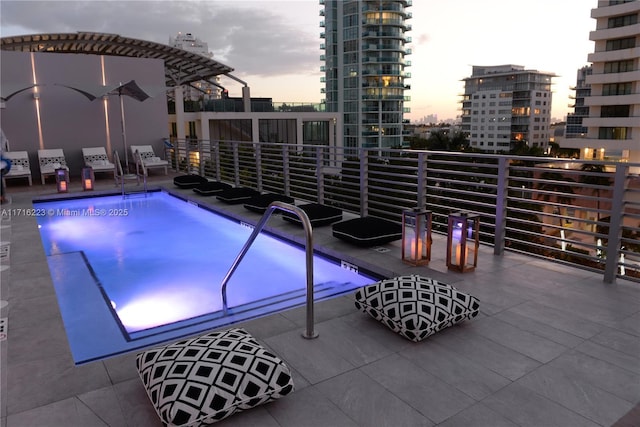 view of pool at dusk