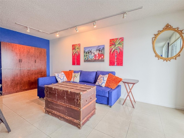 tiled living room with rail lighting and a textured ceiling