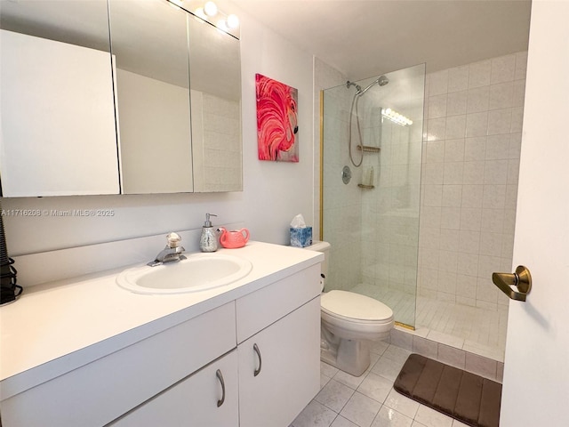 bathroom with a tile shower, tile patterned flooring, vanity, and toilet