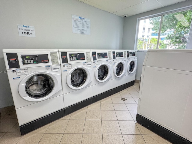 laundry area with light tile patterned floors and separate washer and dryer