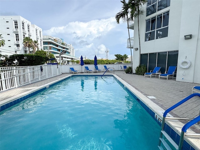 view of swimming pool with a patio