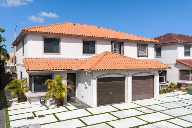 mediterranean / spanish-style home featuring a garage