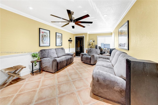 tiled living room with ceiling fan, ornamental molding, and a textured ceiling