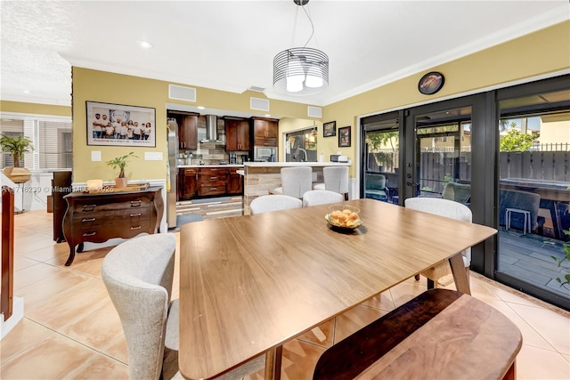 dining room featuring light tile patterned floors and ornamental molding