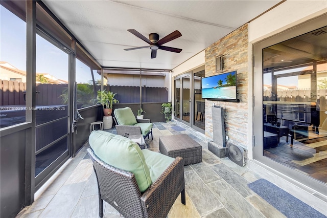 sunroom / solarium with ceiling fan