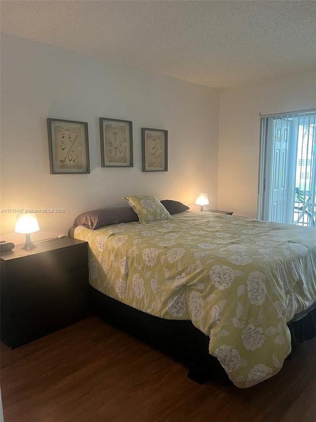 bedroom with hardwood / wood-style flooring and a textured ceiling