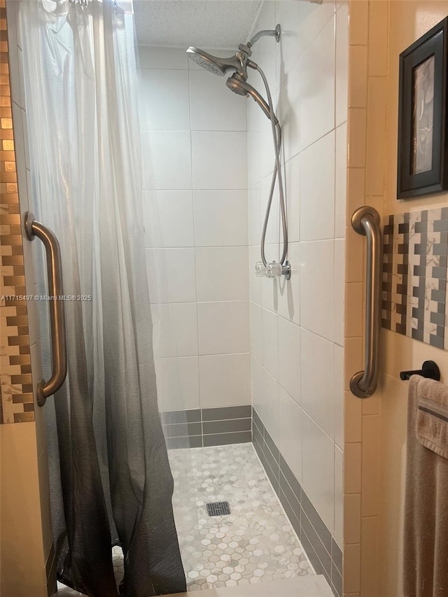 bathroom with curtained shower, a textured ceiling, and tasteful backsplash