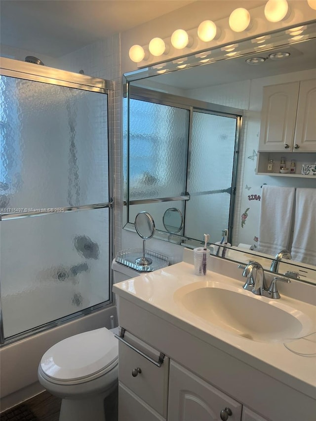 full bathroom with vanity, toilet, and enclosed tub / shower combo