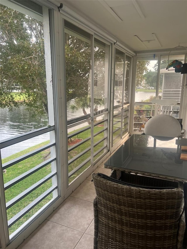 sunroom / solarium with a water view and a wealth of natural light