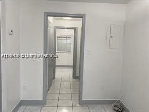 hallway featuring light tile patterned floors