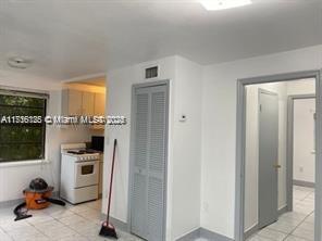 interior space featuring light tile patterned floors and electric range