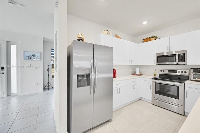 kitchen featuring white cabinetry, light tile patterned flooring, and stainless steel appliances