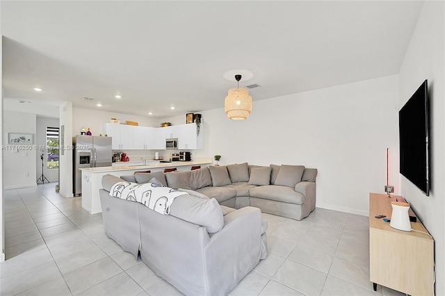 living room featuring light tile patterned floors and sink