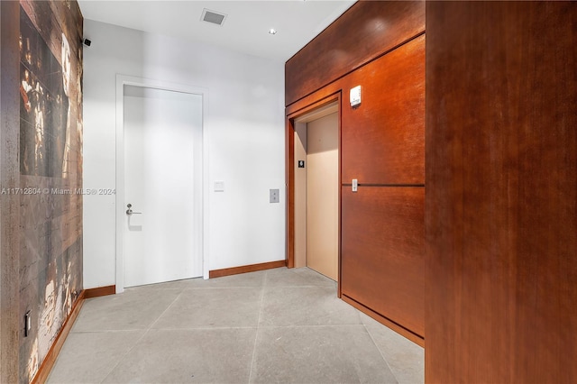 corridor with light tile patterned floors