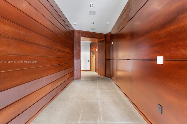 hall featuring wooden walls