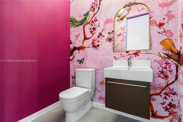 bathroom featuring tile patterned floors, vanity, and toilet