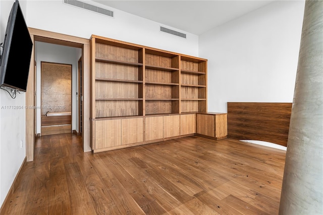 unfurnished room featuring dark wood-type flooring