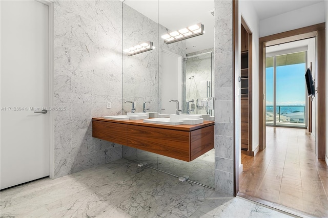 bathroom featuring vanity and tile walls