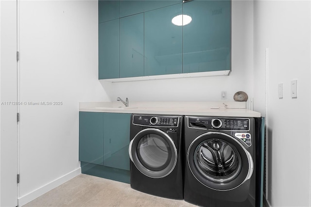 laundry area with cabinets, light tile patterned floors, sink, and washing machine and dryer