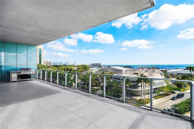 balcony featuring grilling area and a water view