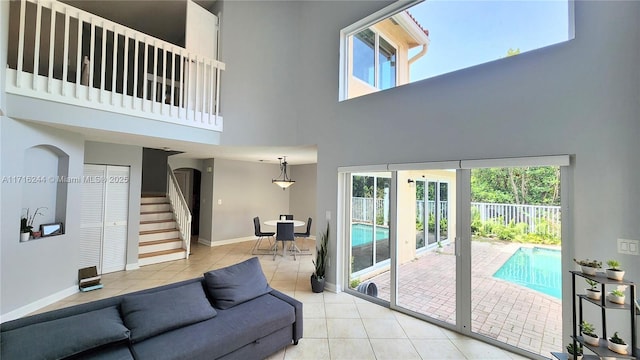 living room featuring light tile patterned floors and a high ceiling