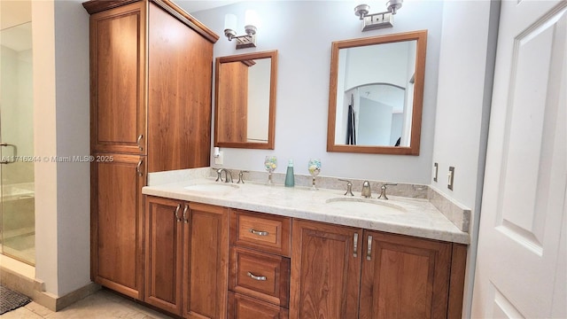 bathroom with tile patterned floors, vanity, and a shower with shower door