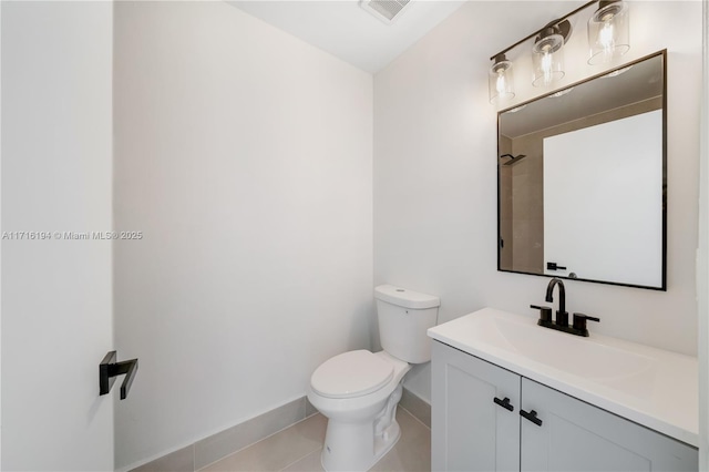 bathroom featuring toilet, vanity, and tile patterned flooring