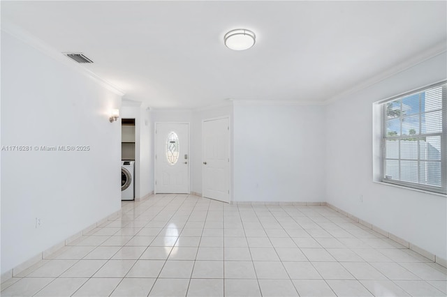 tiled spare room with washer / clothes dryer and crown molding