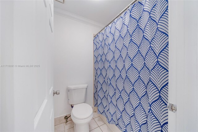 bathroom with crown molding, tile patterned flooring, and toilet