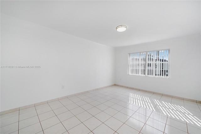 unfurnished room with light tile patterned floors