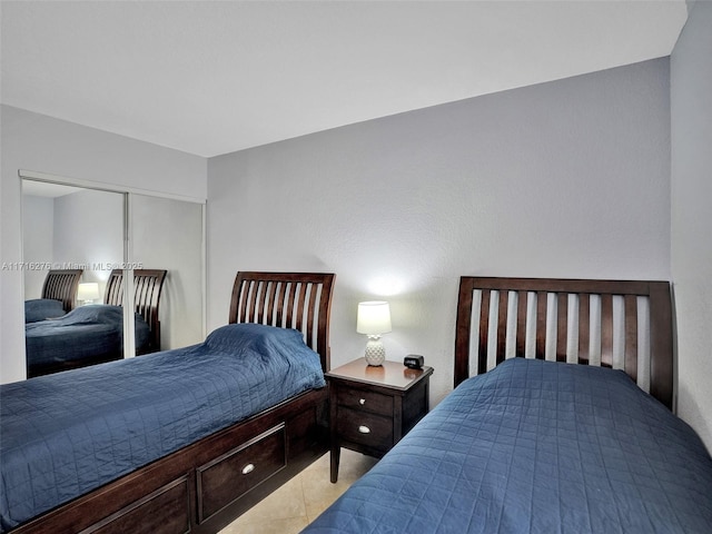 bedroom featuring a closet and light tile patterned floors