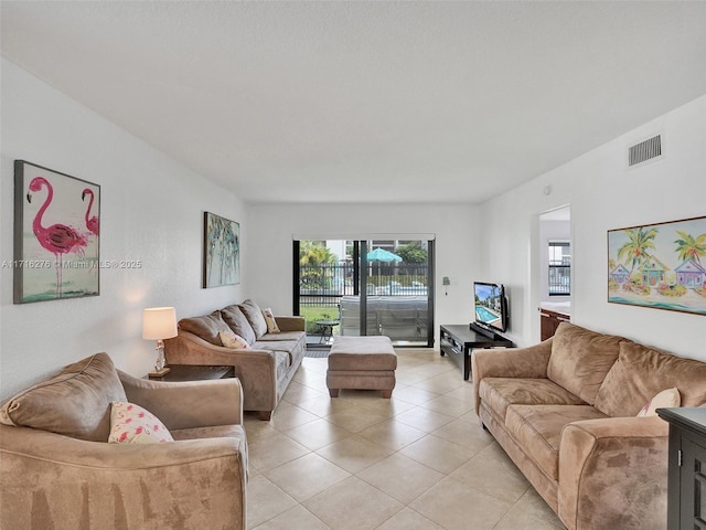 living area with light tile patterned floors and visible vents