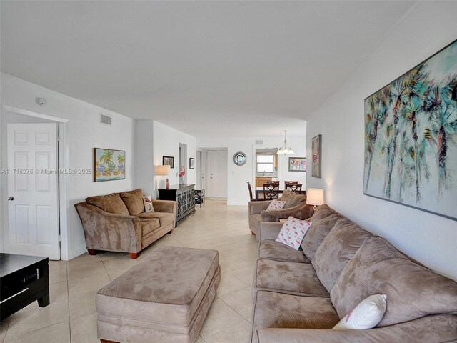 245 SE 10th St Unit 4B, Deerfield Beach, FL 33441 - living room with a chandelier and light tile patterned floors