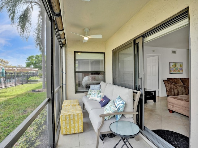 sunroom featuring a ceiling fan and visible vents