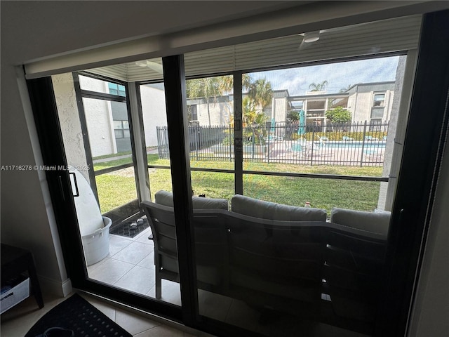 doorway with a wealth of natural light and tile patterned floors