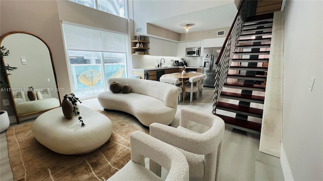 living room with a high ceiling and sink