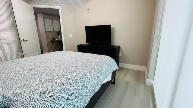 bedroom featuring light hardwood / wood-style flooring and a closet