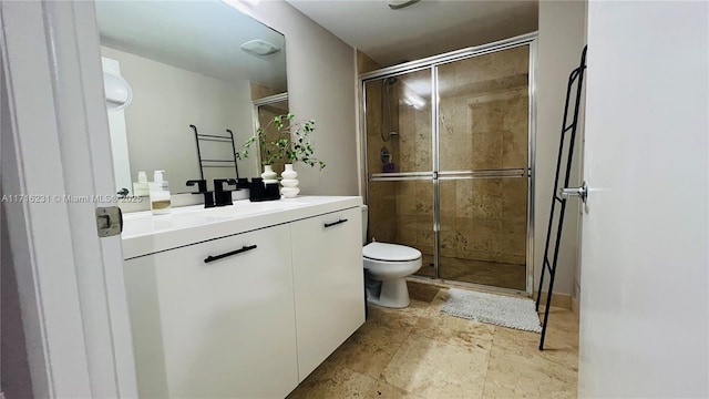 bathroom with vanity, toilet, and an enclosed shower