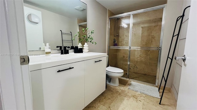 bathroom with vanity, an enclosed shower, and toilet