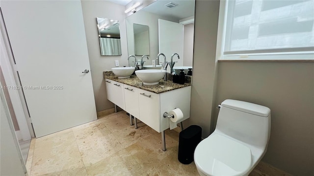 bathroom with vanity and toilet