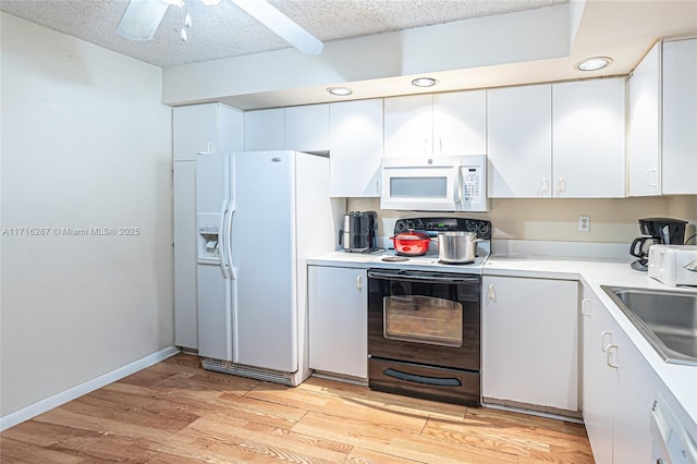 kitchen with white cabinetry, sink, light hardwood / wood-style floors, a textured ceiling, and white appliances