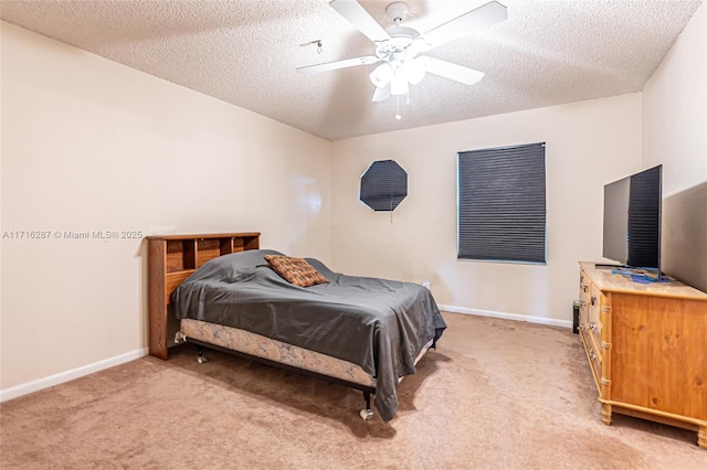 bedroom with ceiling fan, a textured ceiling, and light carpet