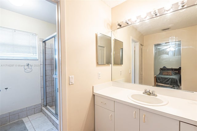 bathroom featuring tile patterned floors, vanity, and an enclosed shower