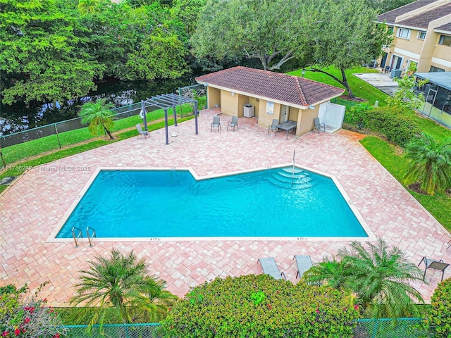 view of swimming pool with a patio area and an outbuilding